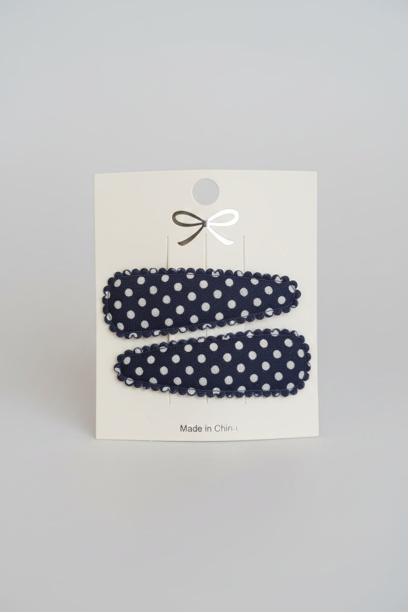 Kind klikspeld donkerblauw met witte stippen
