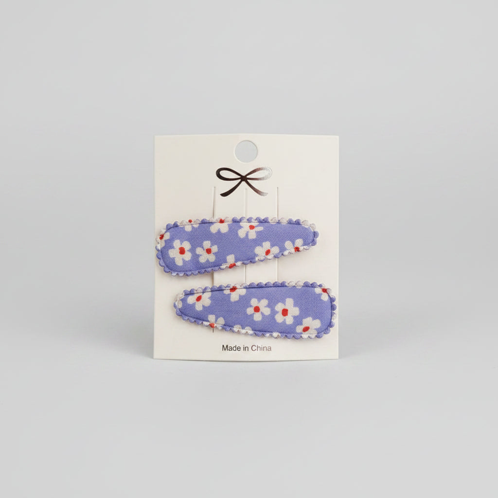 Kind klikspeld paars met witte bloemen en gekleurde stippen
