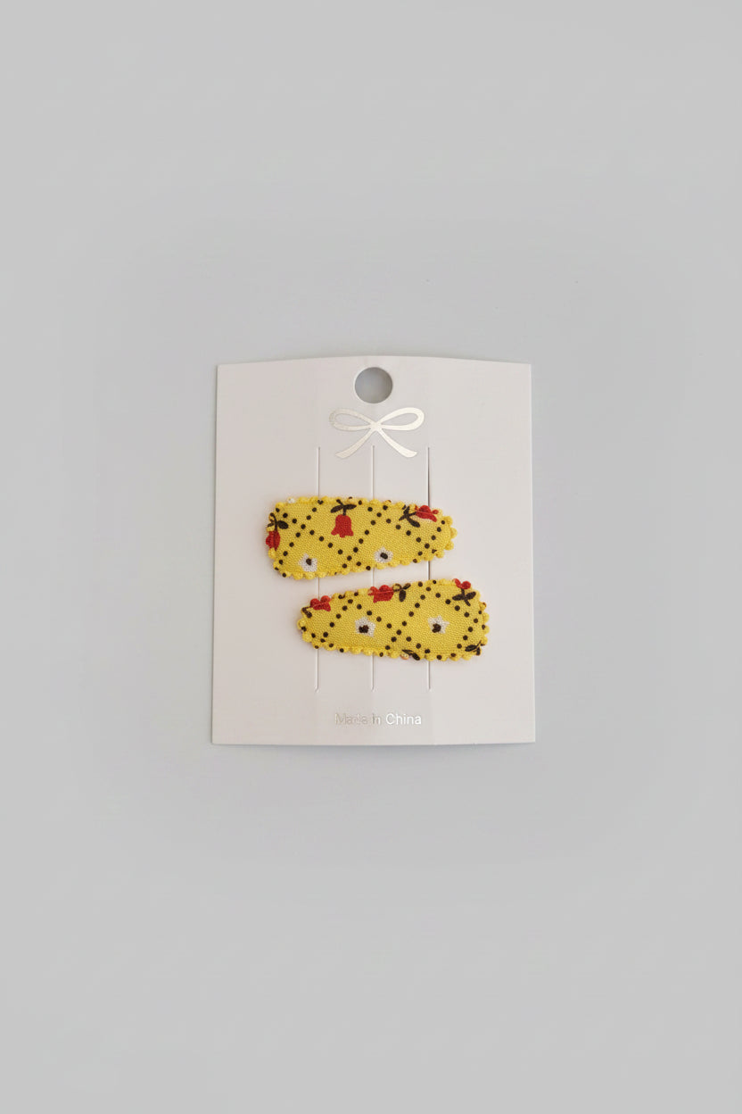 Baby klikspeld geel met kleine bloemetjes