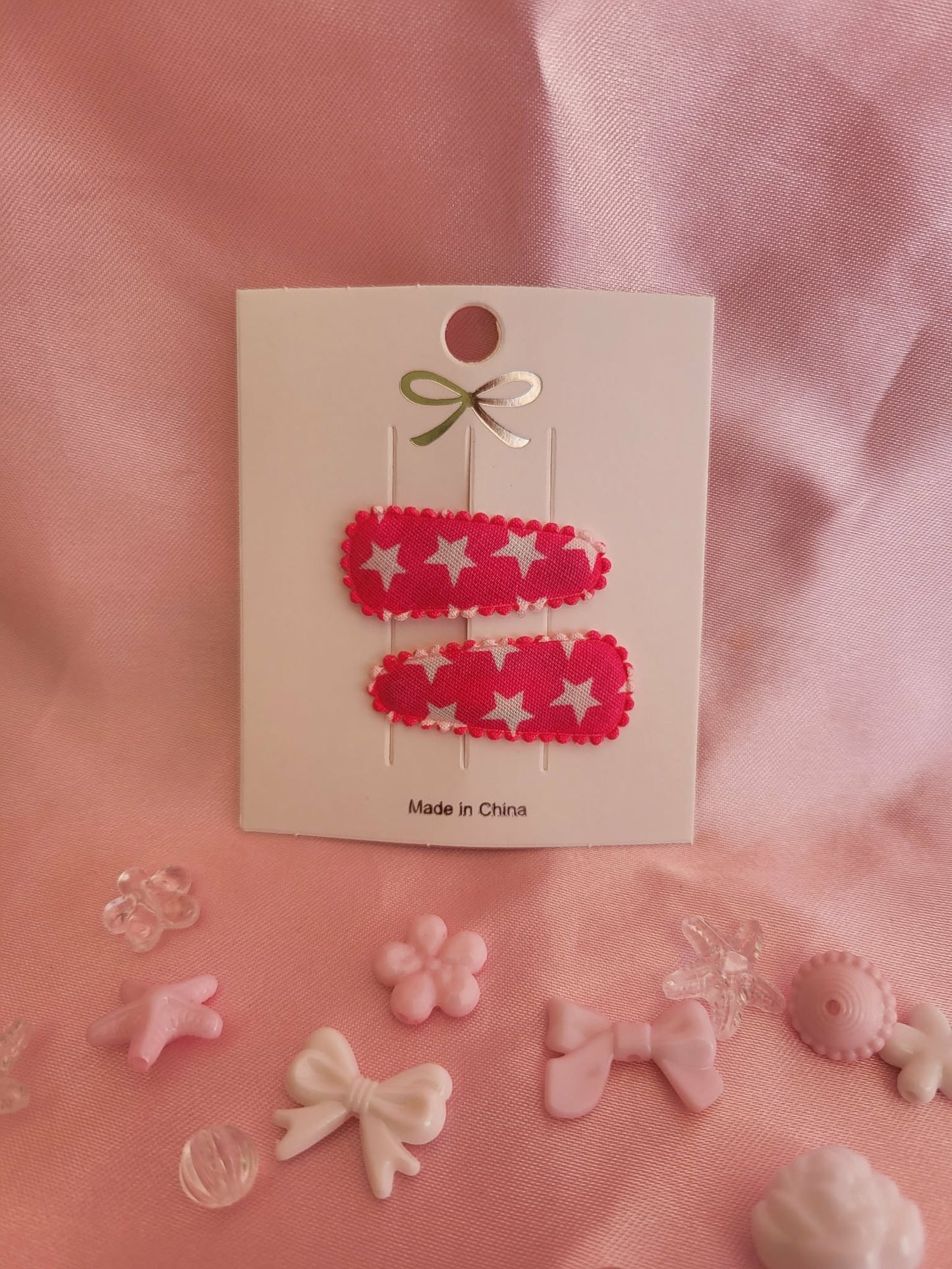 Baby klikspeld roze met witte sterren