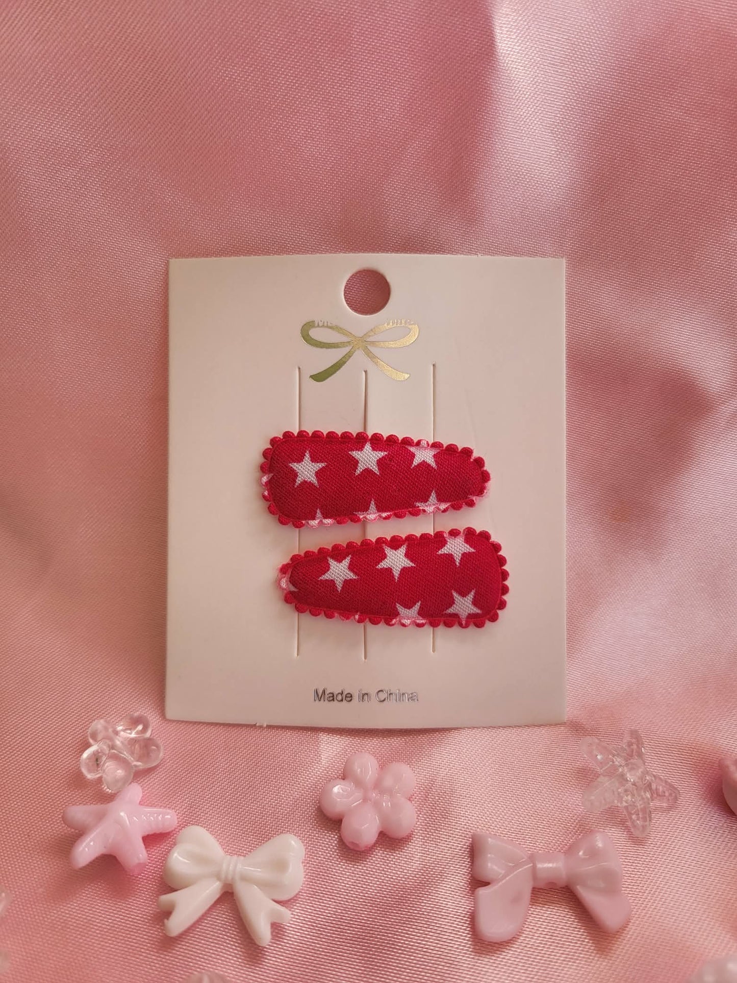 Baby klikspeld donkerroze met witte sterren