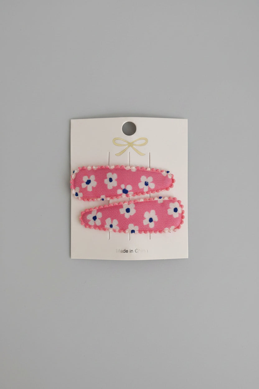 Kind klikspeld roze met witte bloemen