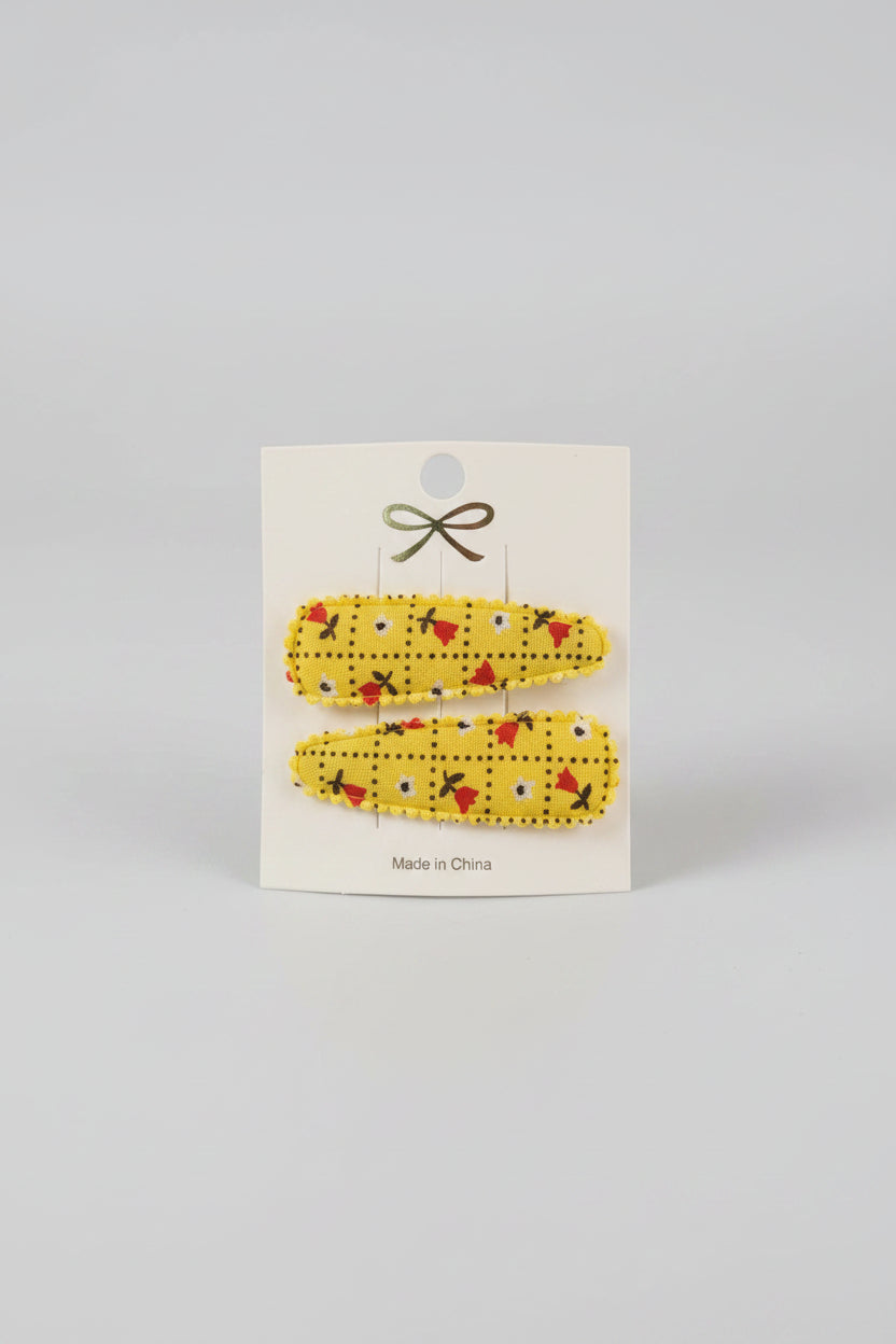 Kind klikspeld geel met kleine bloemetjes