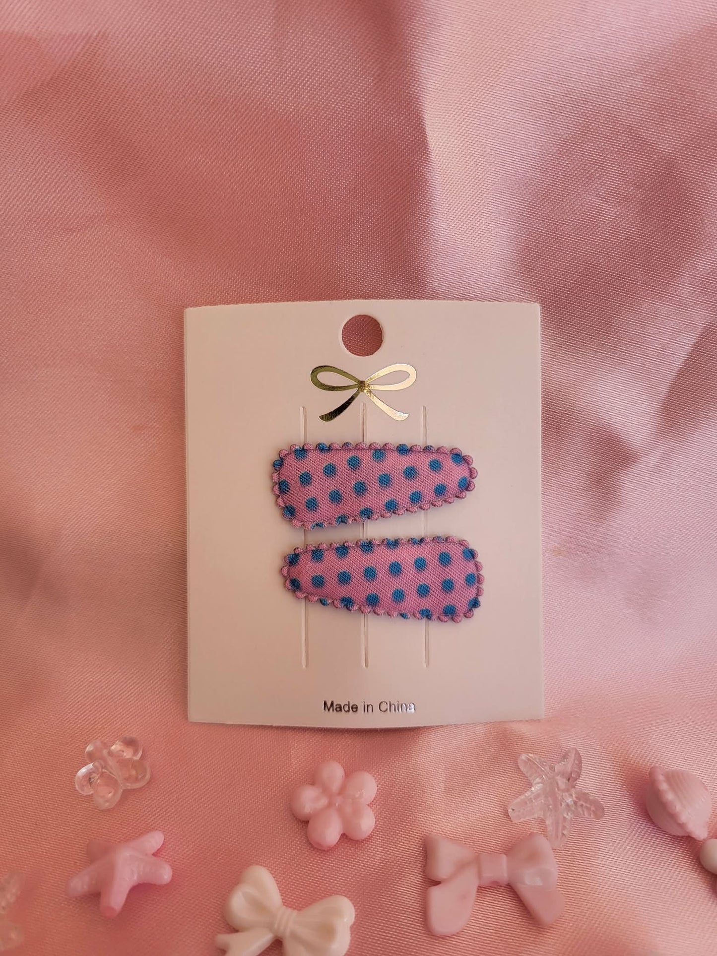 Baby klikspeld roze met blauwe stippen