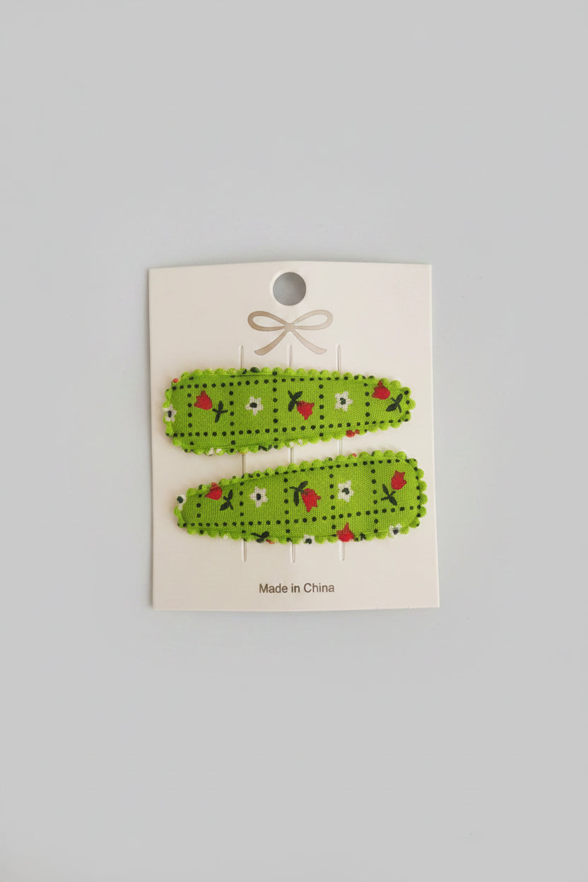 Kind klikspeld groen met kleine bloemetjes