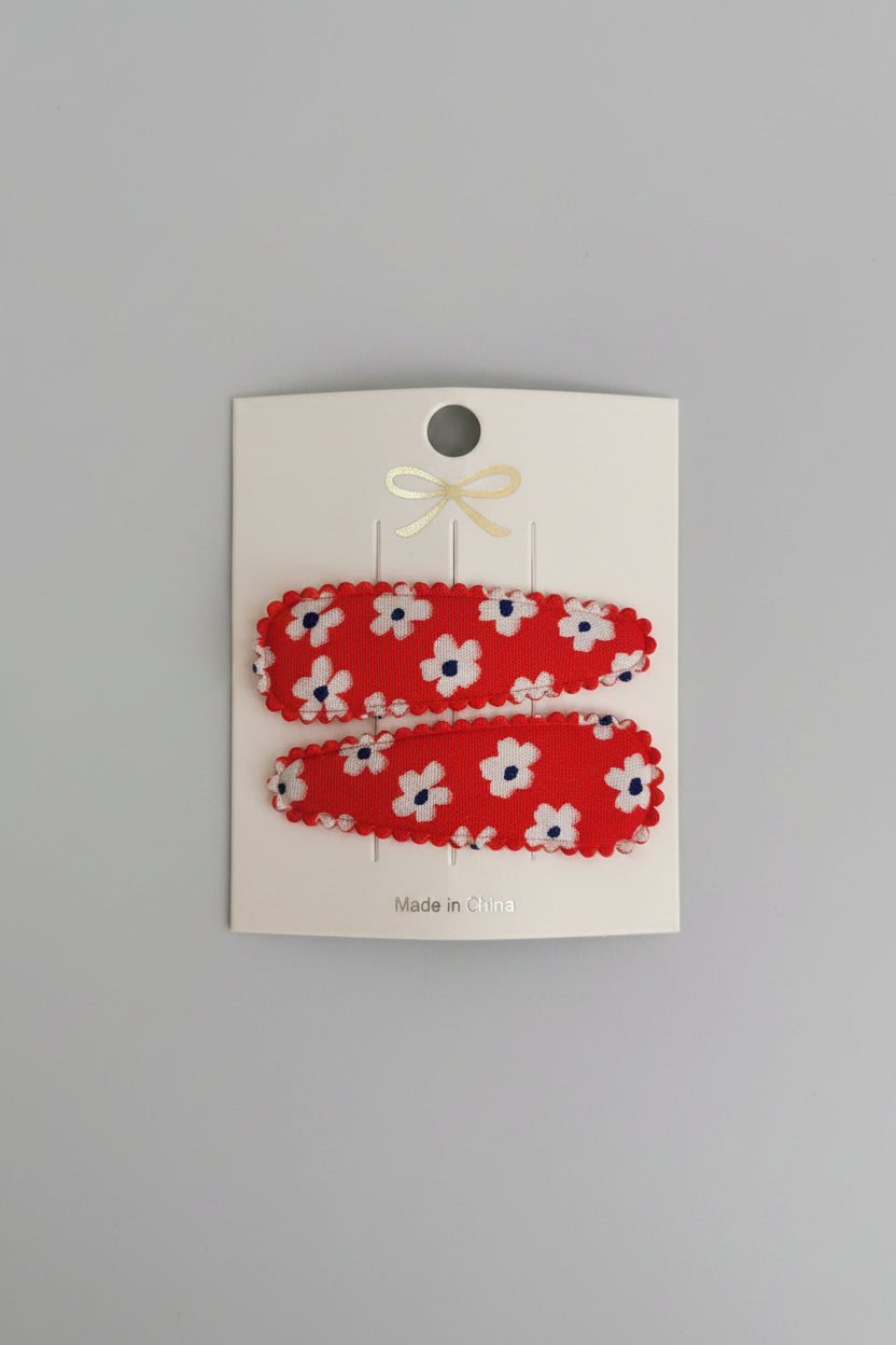 Kind klikspeld rood met witte bloemen