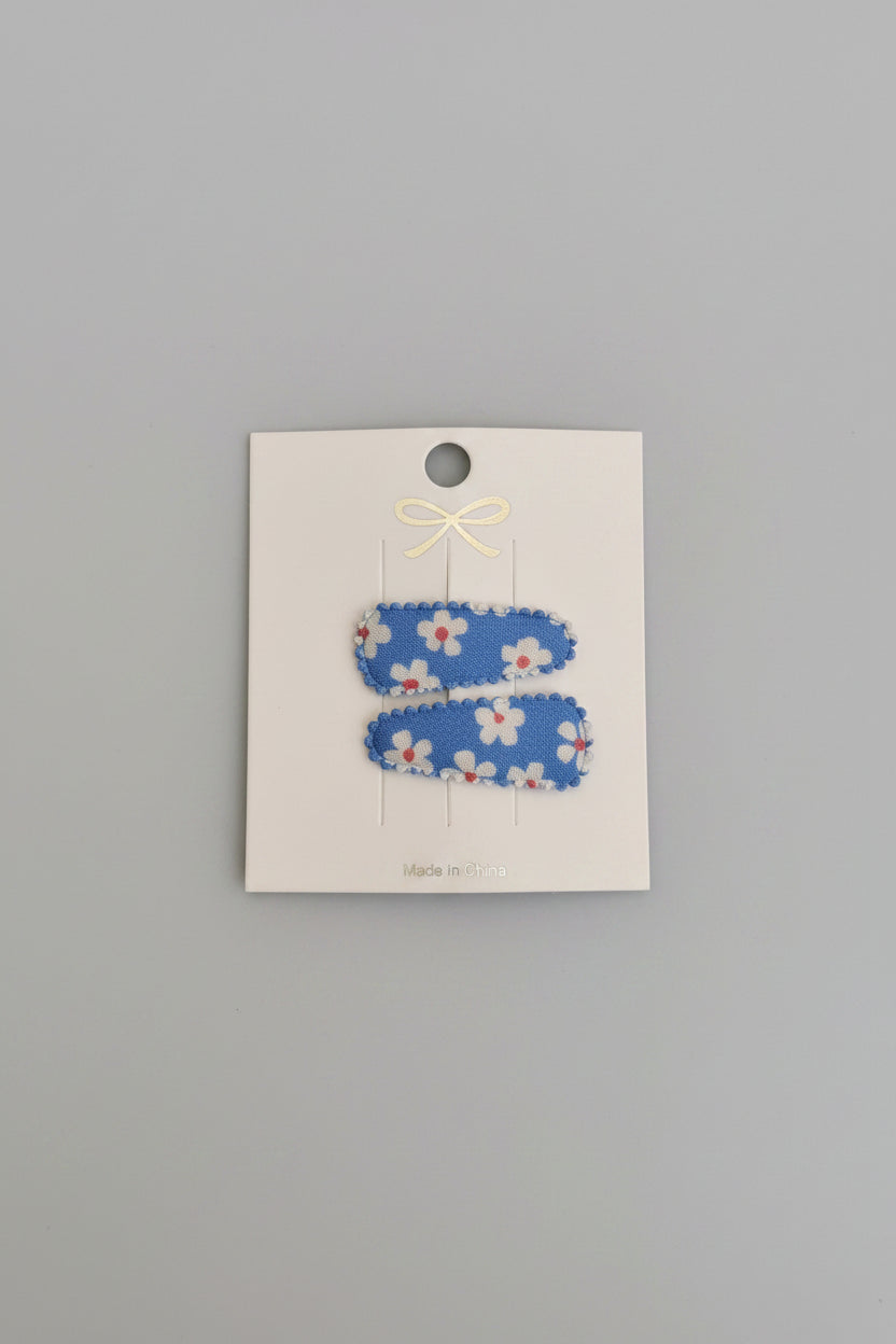 Baby klikspeld blauw met witte bloemen