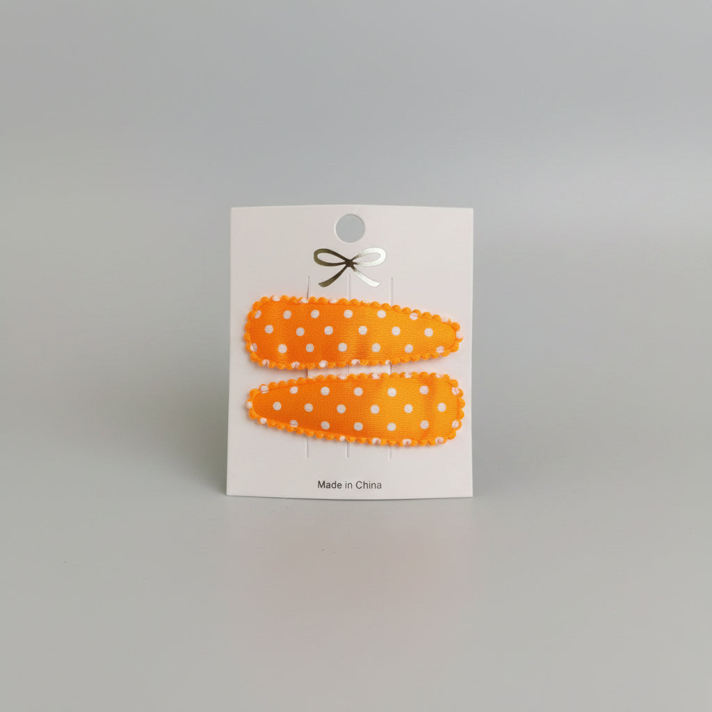 Kind klikspeld satijn oranje met witte stippen