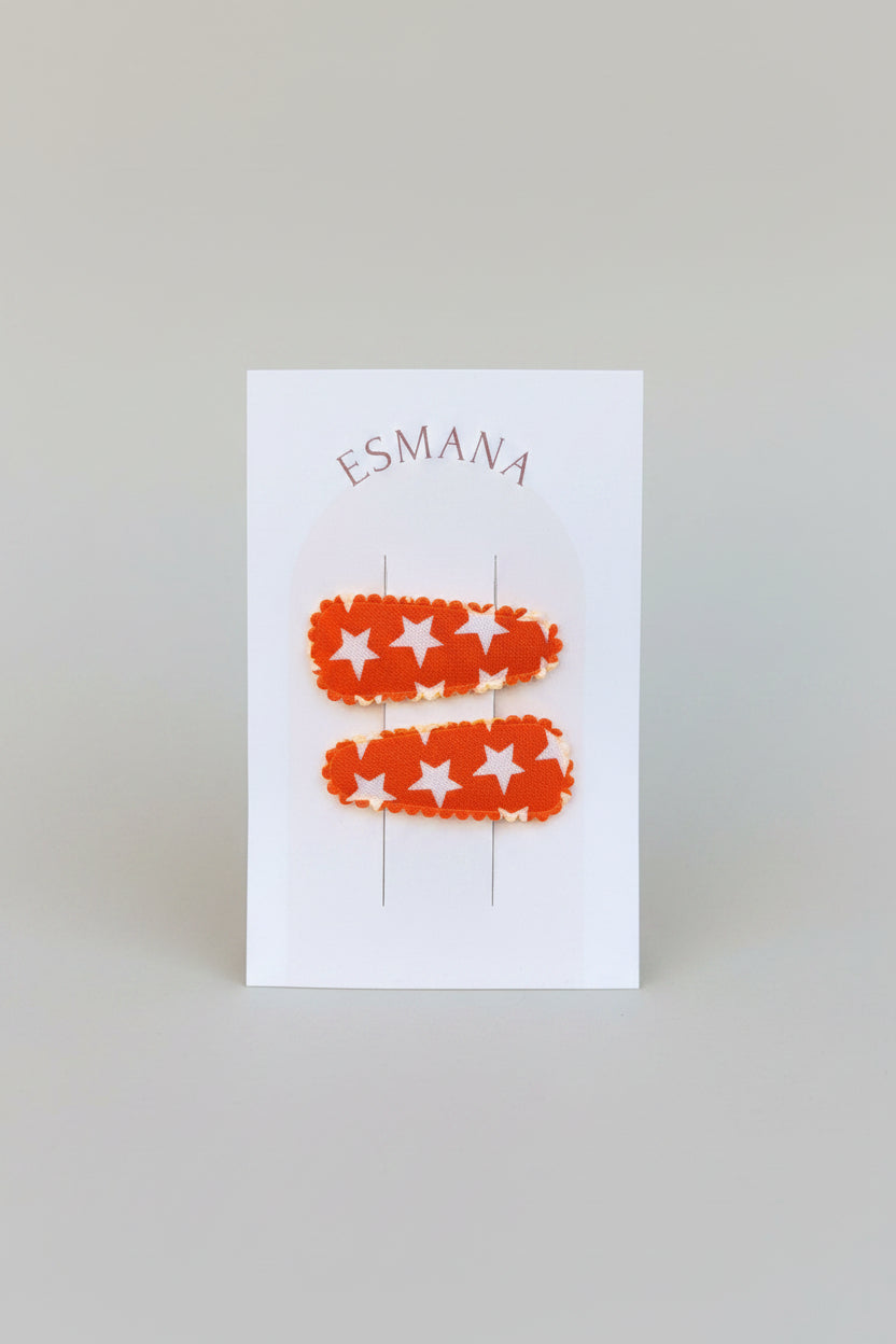Baby klikspeld oranje met witte sterren