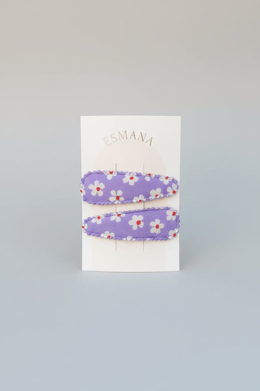 Kind klikspeld paars met witte bloemen en gekleurde stippen