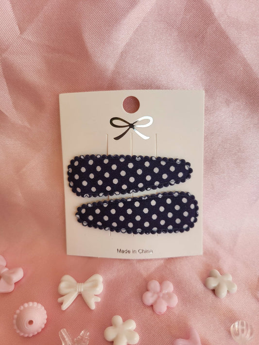 Kind klikspeld donkerblauw met witte stippen
