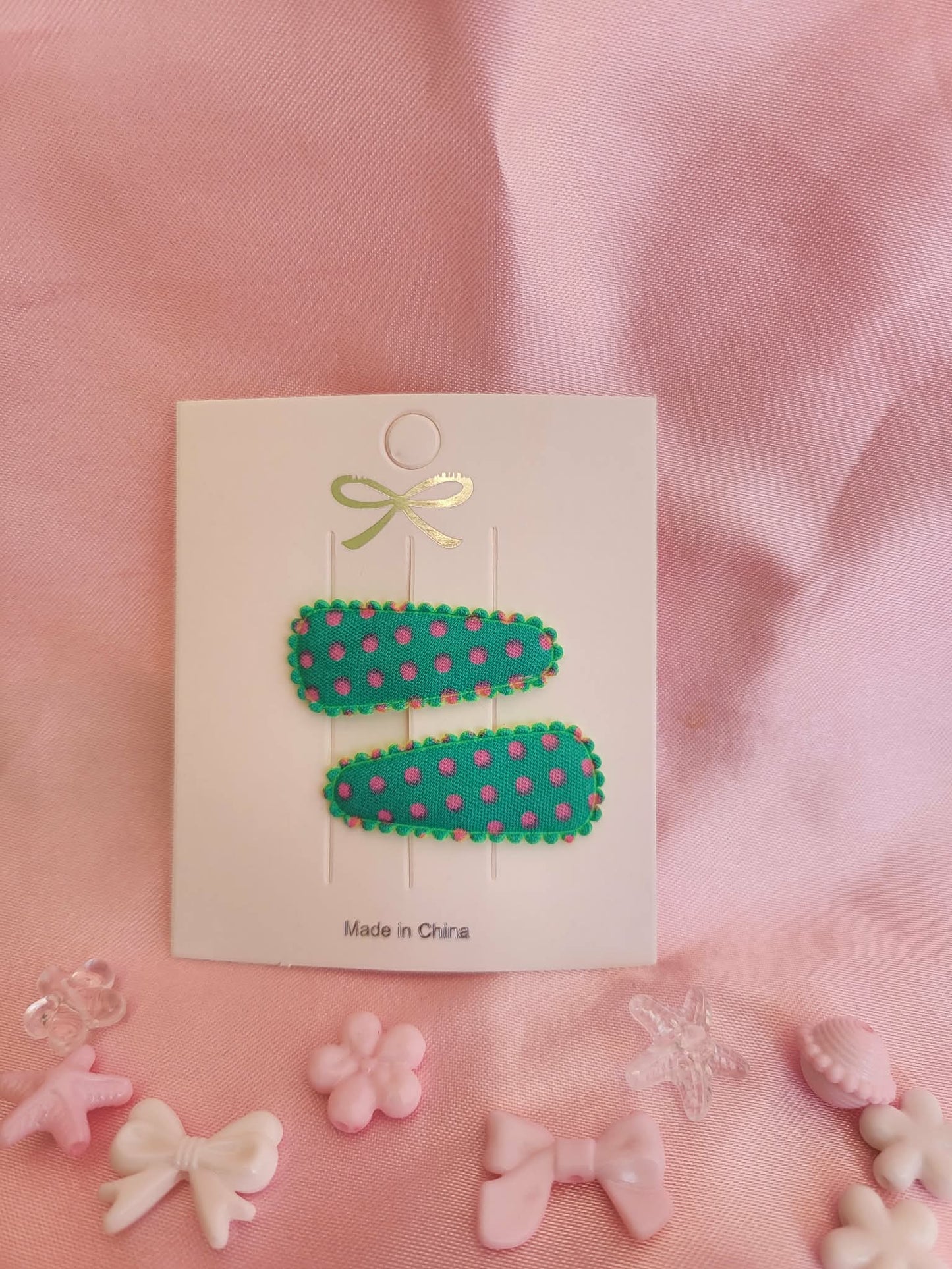 Baby klikspeld groen met roze stippen