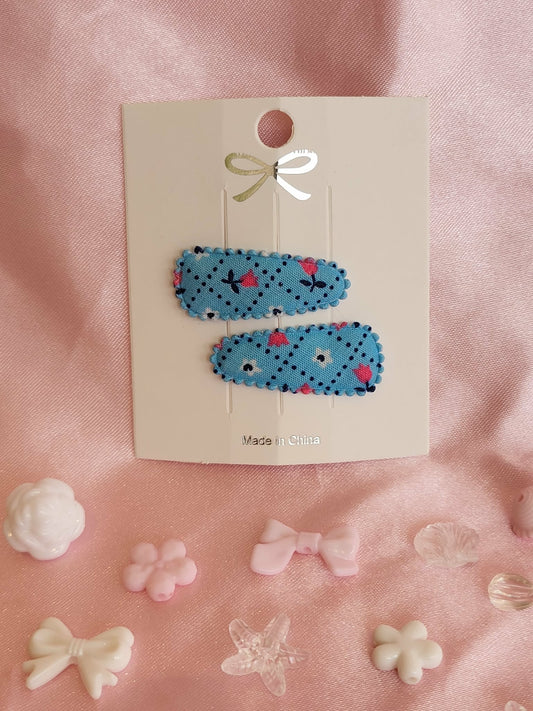 Baby klikspeld blauw met kleine bloemetjes