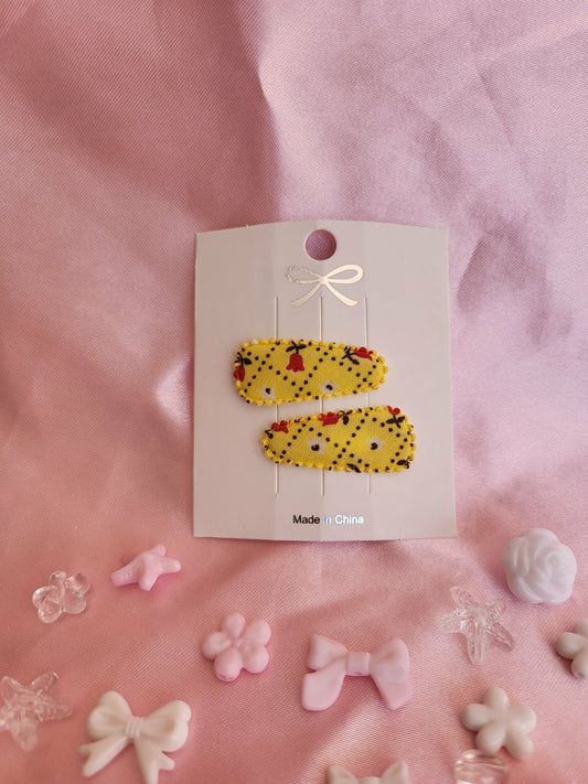 Baby klikspeld geel met kleine bloemetjes