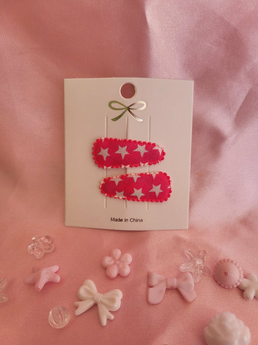 Baby klikspeld roze met witte sterren
