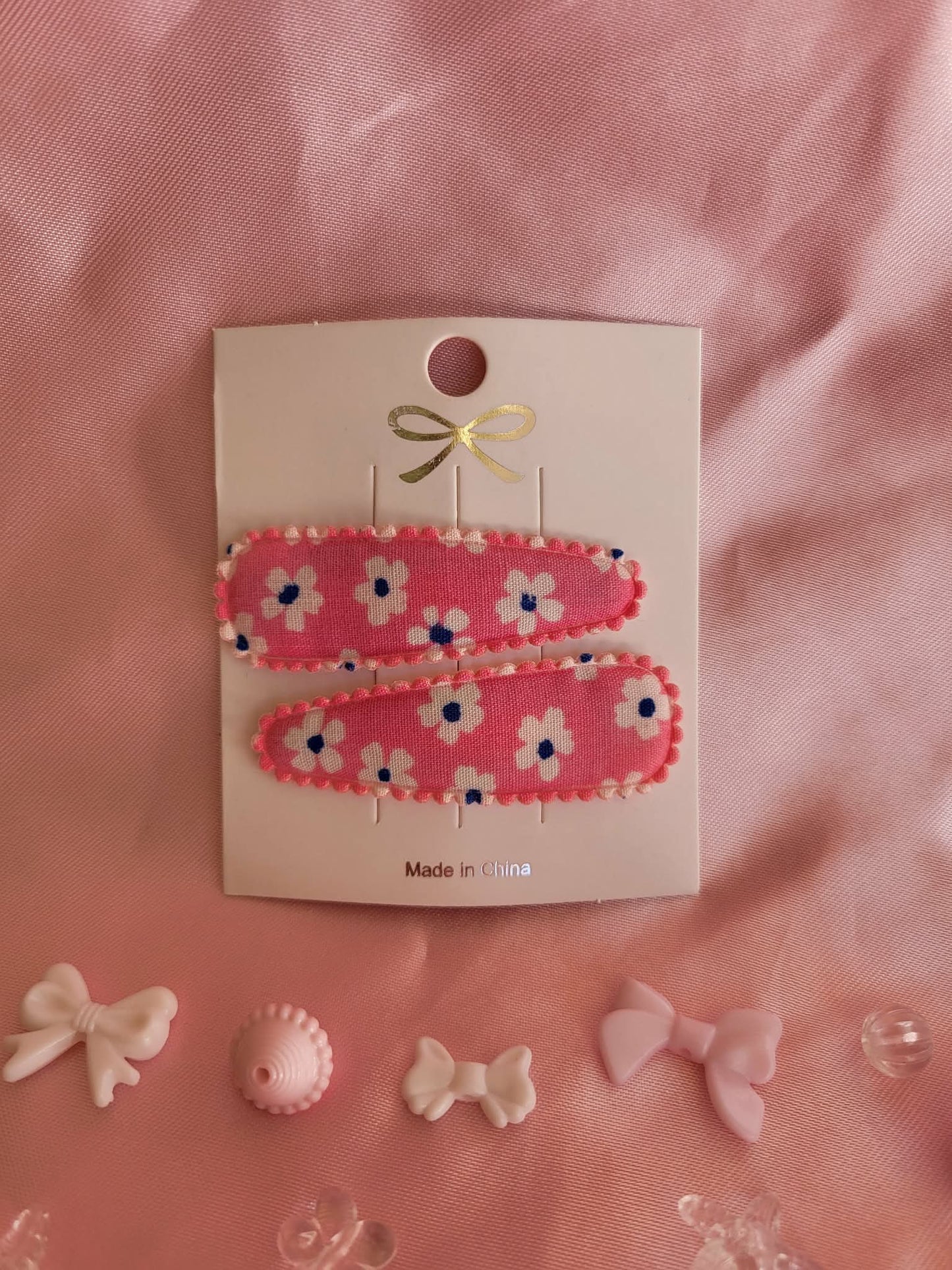 Kind klikspeld roze met witte bloemen