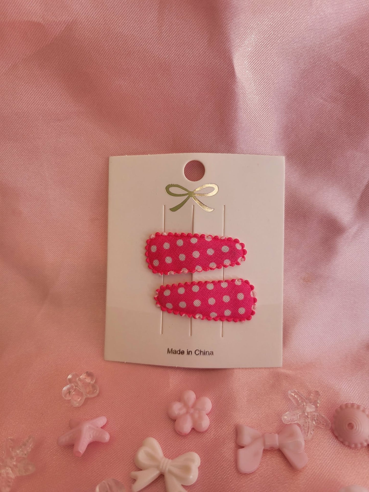 Baby klikspeld roze met witte stippen
