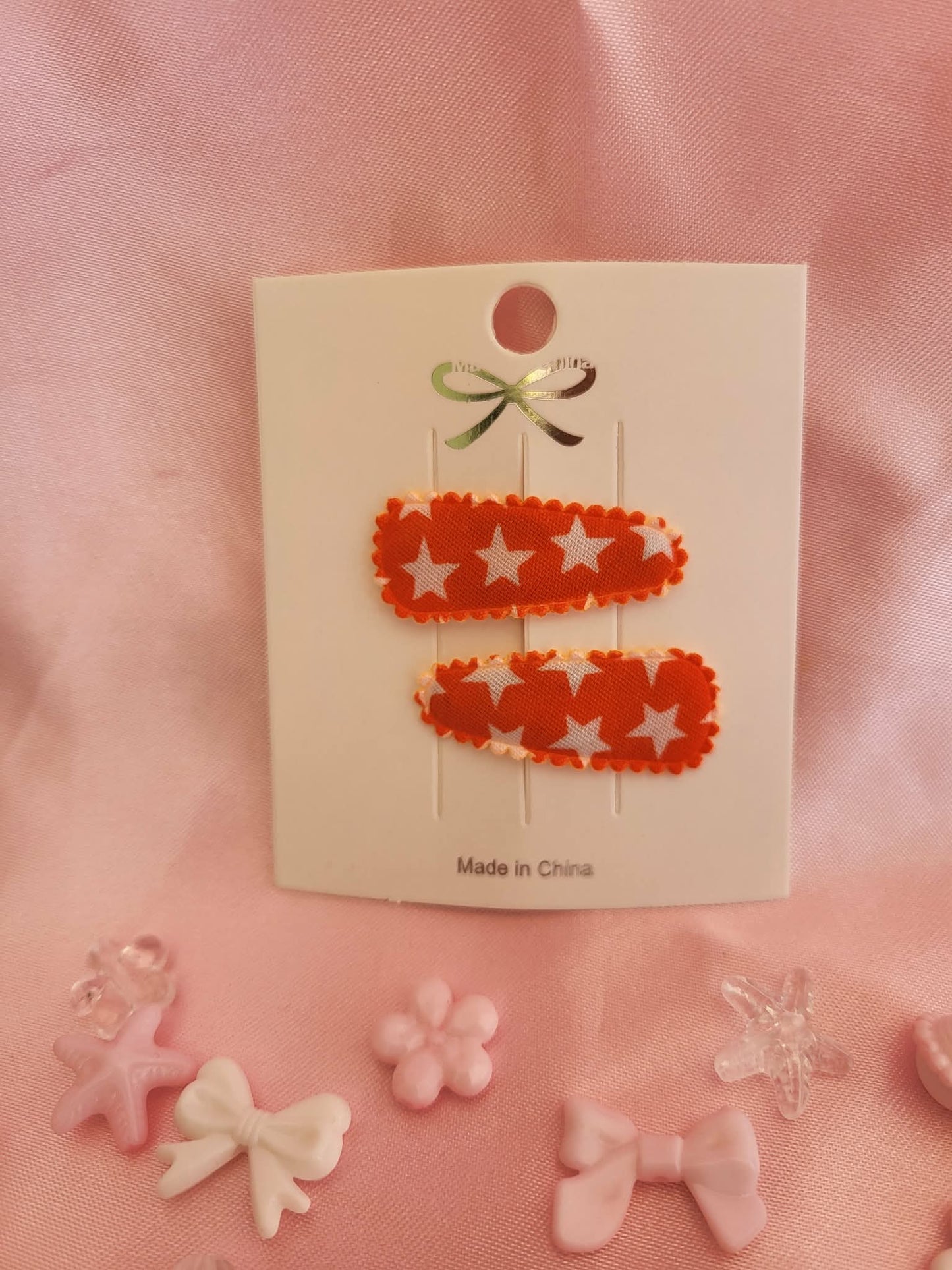 Baby klikspeld oranje met witte sterren