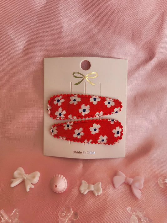 Kind klikspeld rood met witte bloemen