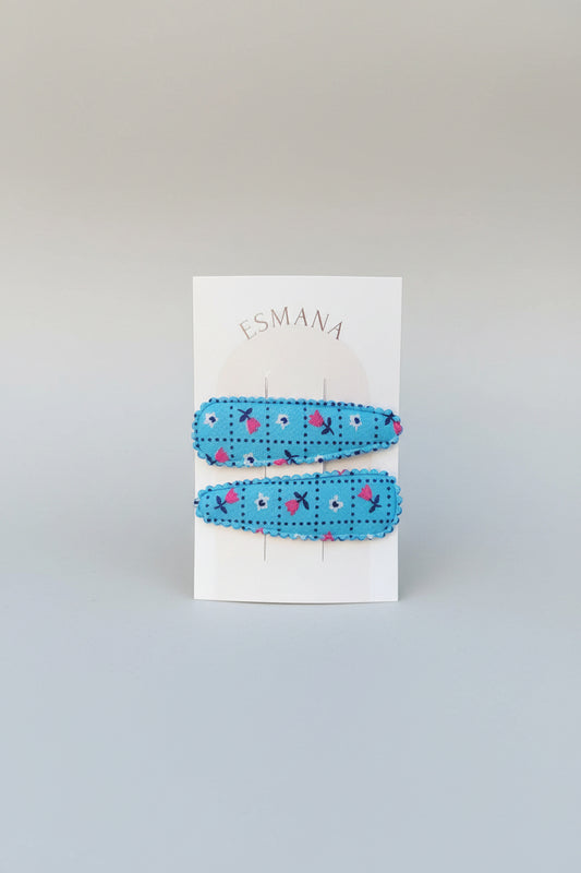 Kind klikspeld blauw met kleine bloemetjes