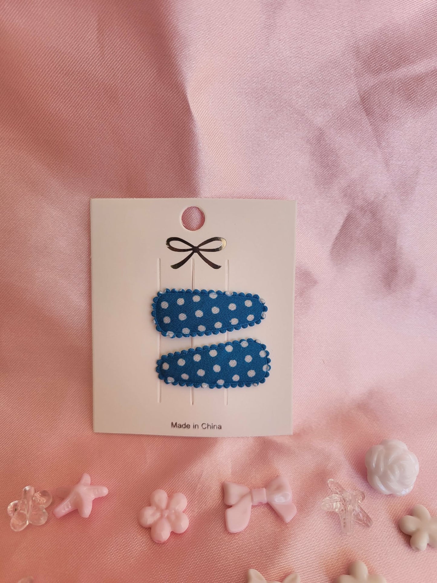 Baby klikspeld donkerblauw met witte stippen