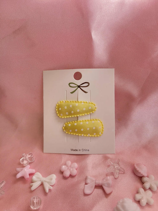 Baby klikspeld satijn geel met witte stippen