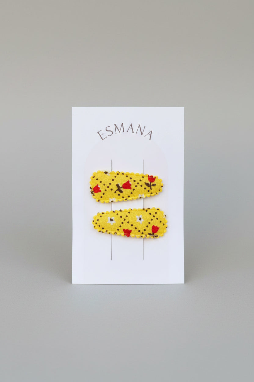 Baby klikspeld geel met kleine bloemetjes
