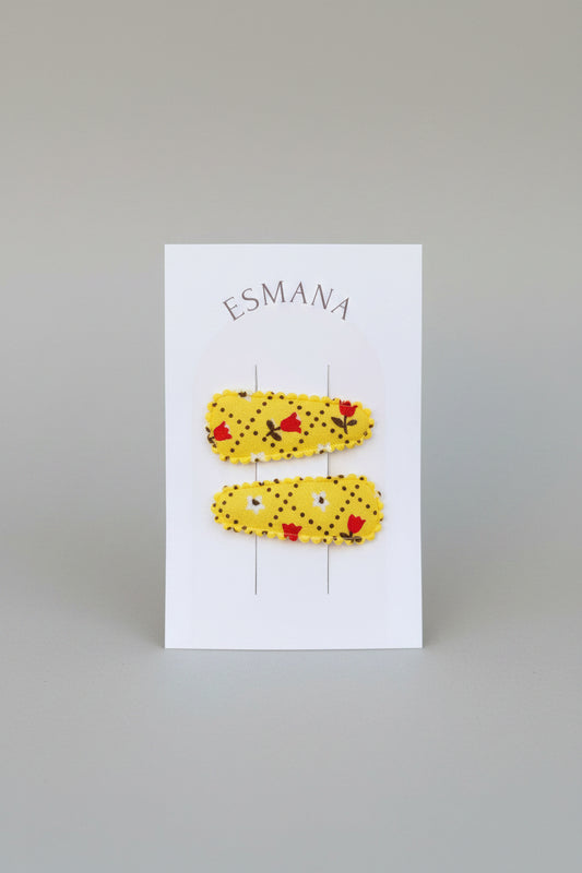Baby klikspeld geel met kleine bloemetjes