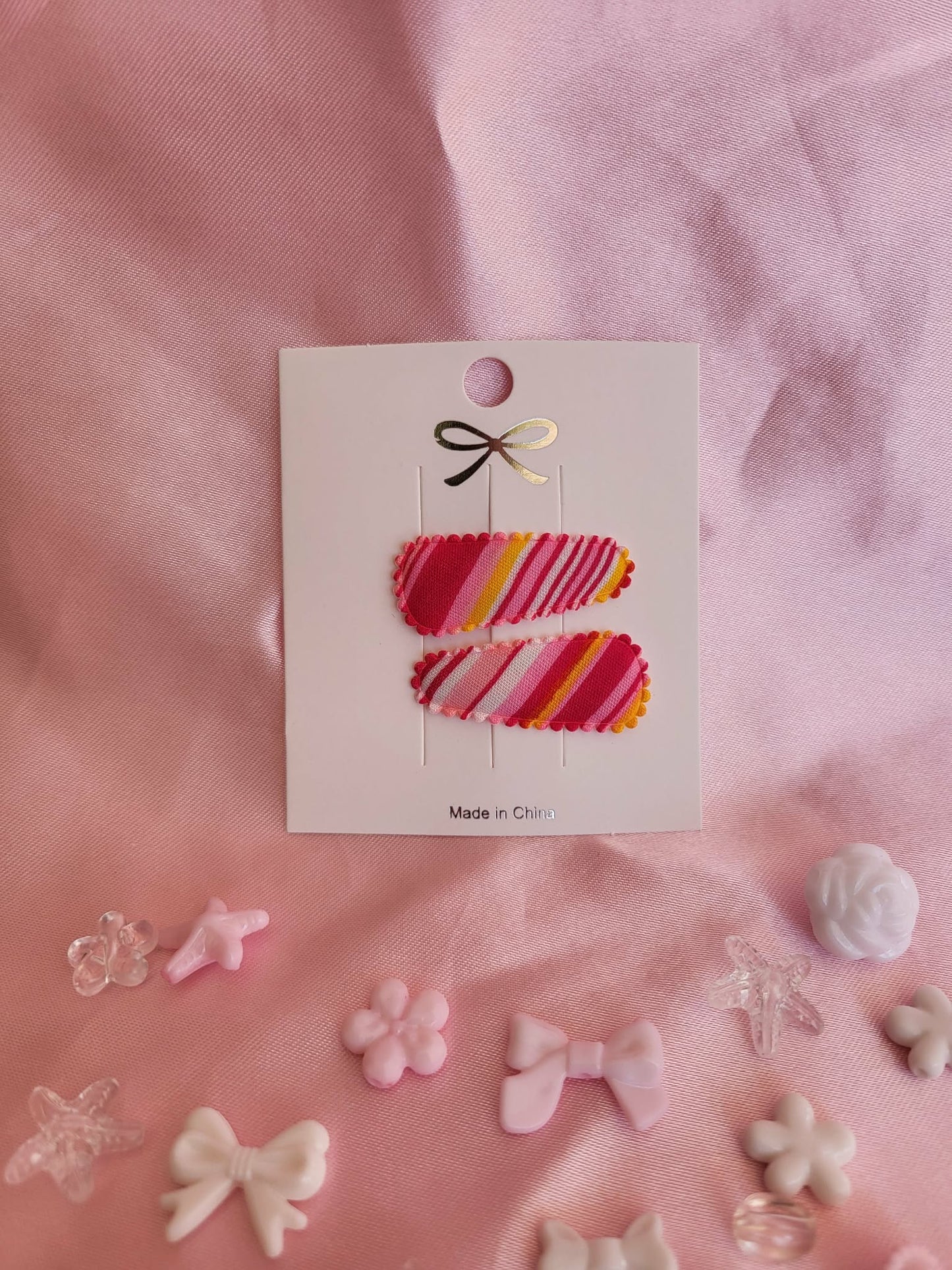Baby klikspeld gestreepte roze tinten