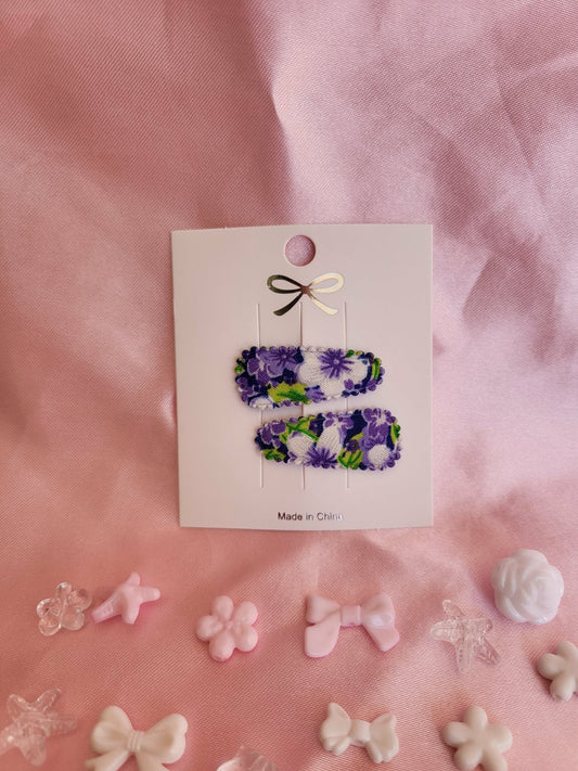 Baby klikspeld met paarse bloemen
