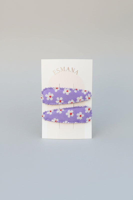 Kind klikspeld paars met witte bloemen en gekleurde stippen